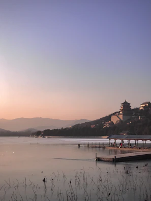 Cover of a novel featuring a serene lakeside at sunset.