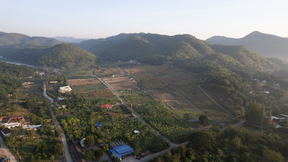 an aerial view of a rural area with mountains in the background