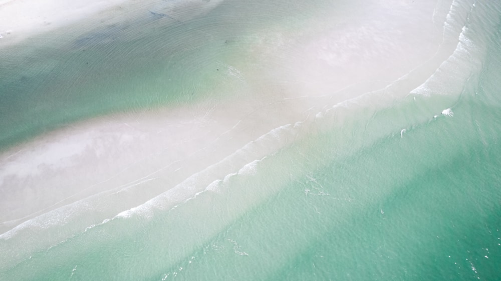 a bird's eye view of the water and sand