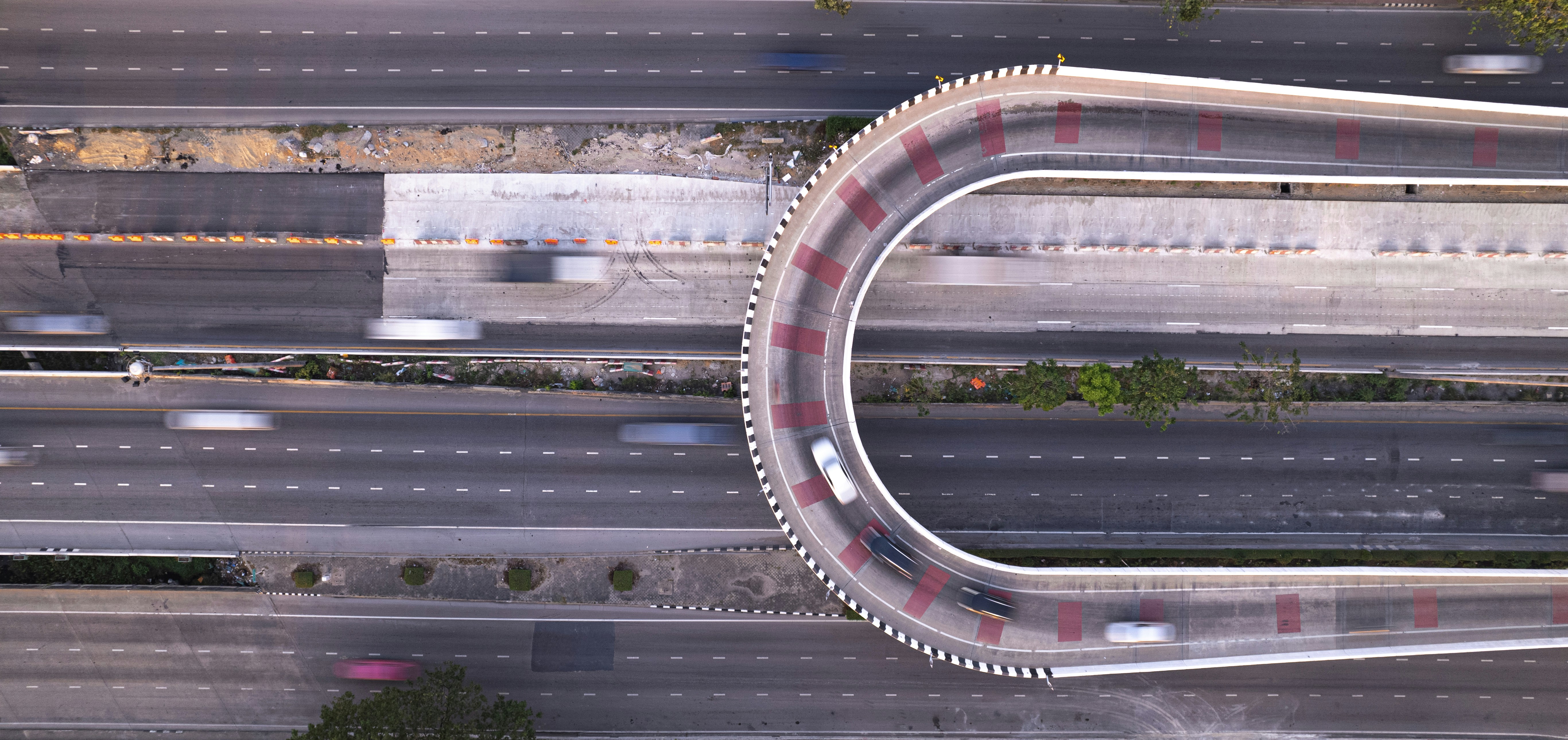 an aerial view of a highway with a curved road