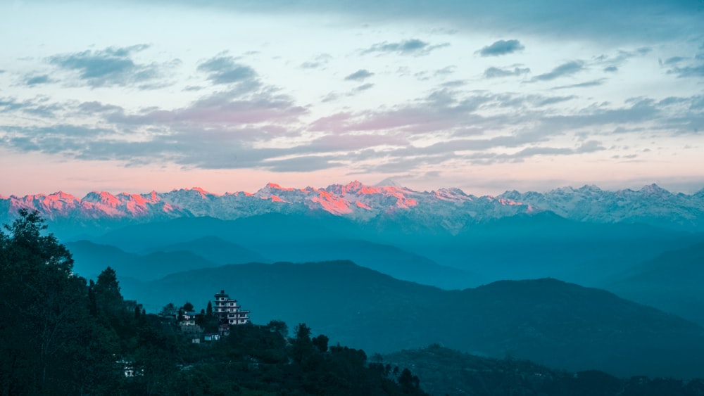 a view of a mountain range with a castle in the foreground