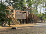 Wooden playground with slides and swings assembled by Brinqueviva team.