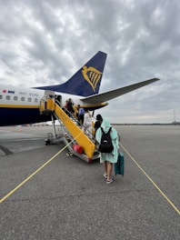 A group of travelers happily boarding a plane.