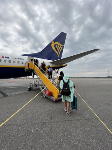 A group of travelers happily boarding a plane.