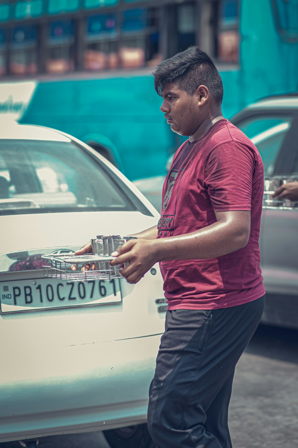 a man standing next to a white car