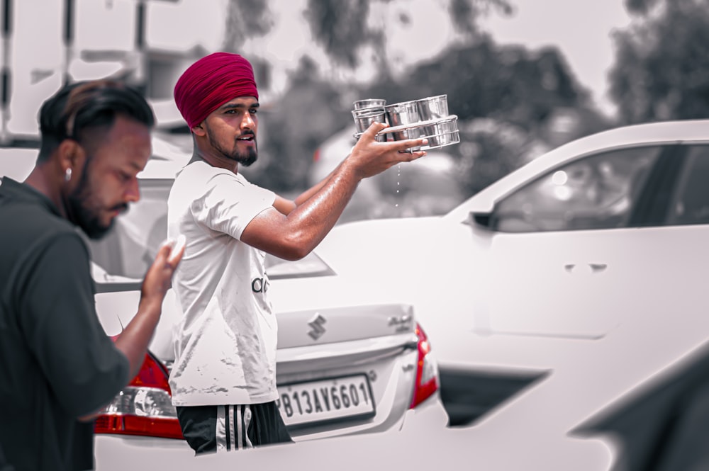 a man in a turban holding a glass of water