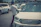 A professional driver handing over car keys to a relieved customer amid a modern transport truck.
