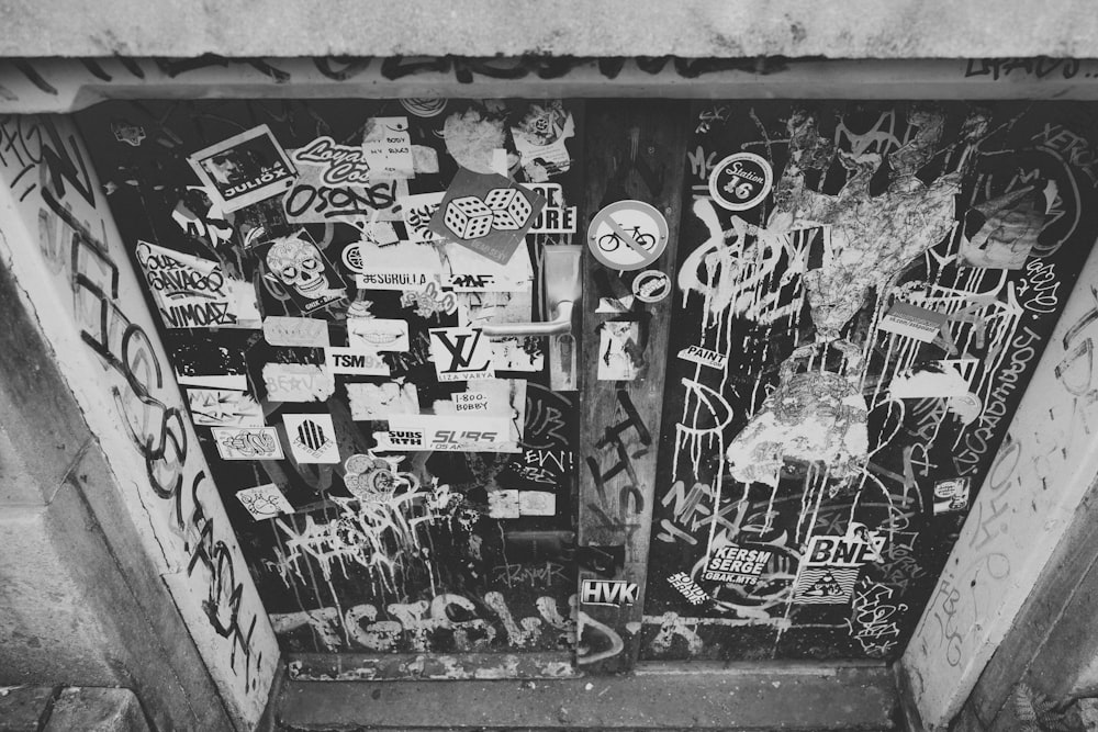 black and white photograph of graffiti on a door
