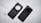 Two black mobile phone cases are placed side by side on a textured light gray surface. One case has a circular cutout for the camera, while the other is designed to highlight the camera module with lenses visible.