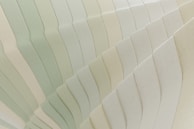 A close-up of layered colors blending softly, highlighting delicate light reflections.