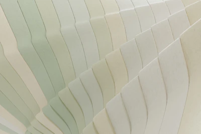 Handmade wall art with textured layers and subtle pastel hues.