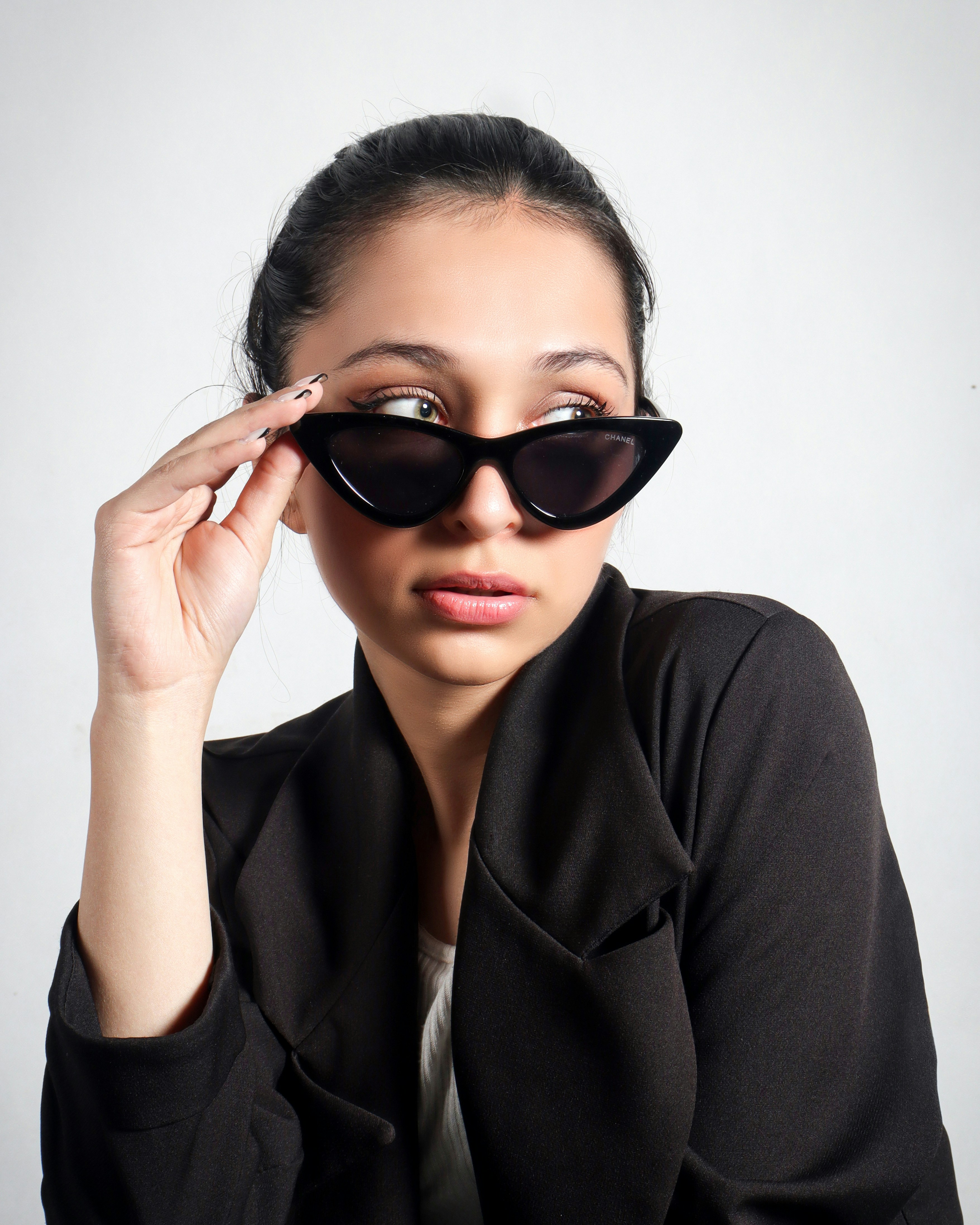 a woman wearing a black jacket and sunglasses