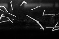 Surveyor marking points on the ground with chalk lines under bright daylight.