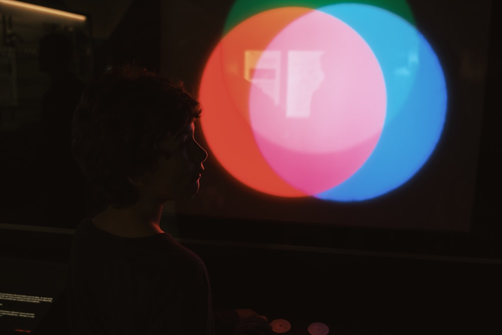 a person standing in front of a large screen