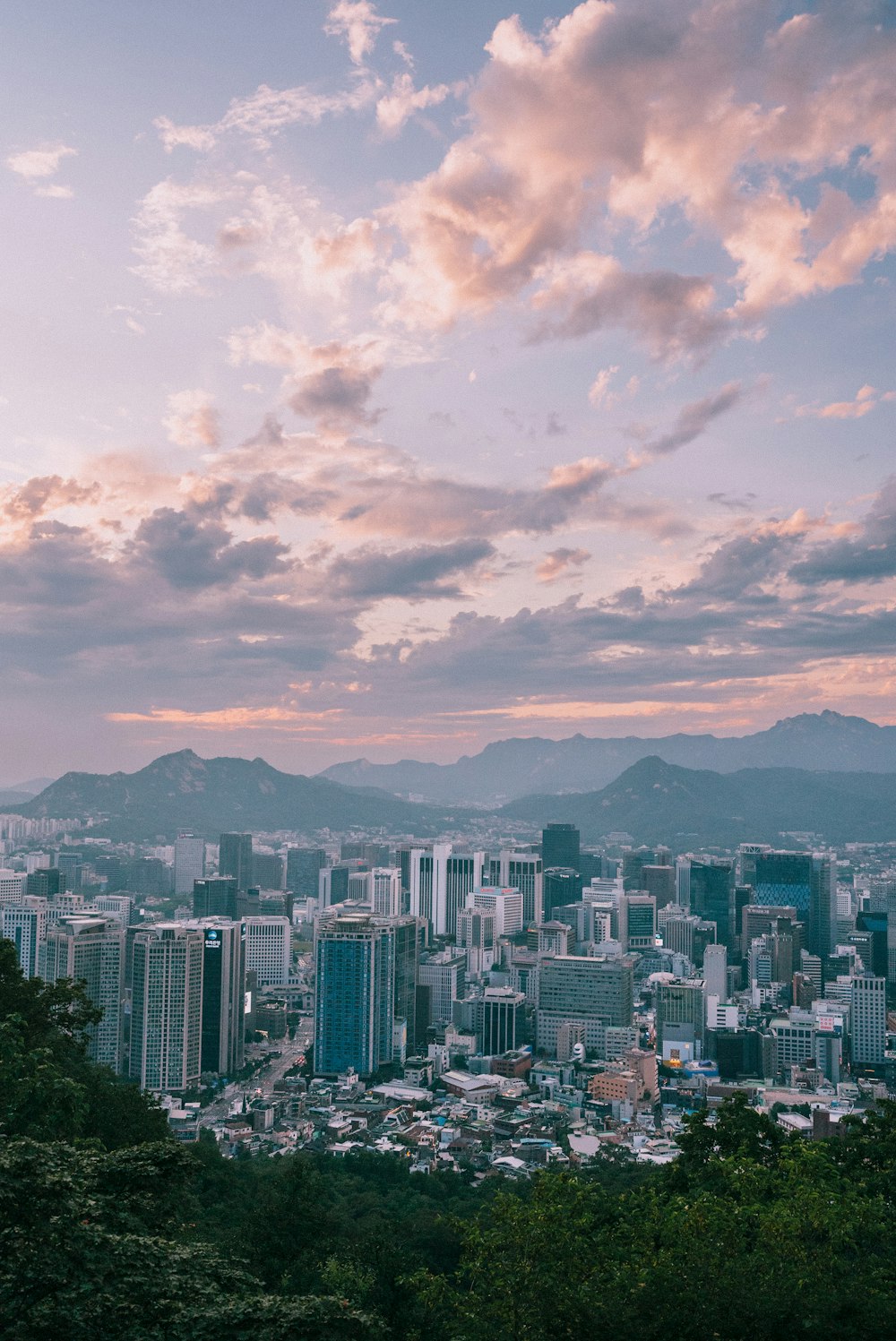 a view of a city with mountains in the background