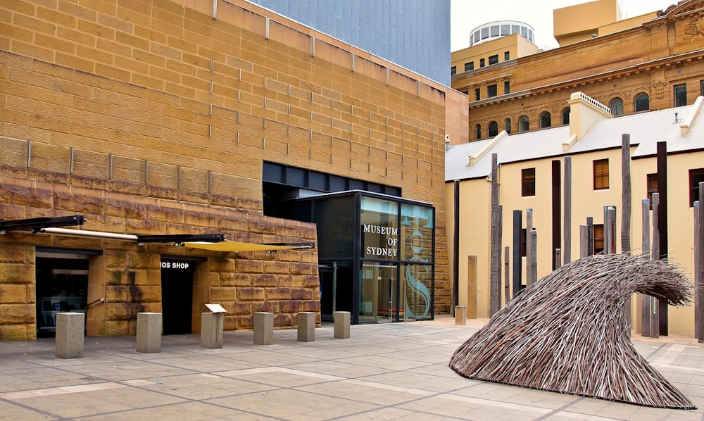 a sculpture of a bird in front of a building