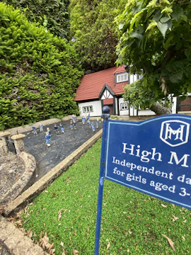 Young learners building a model village with recycled materials.