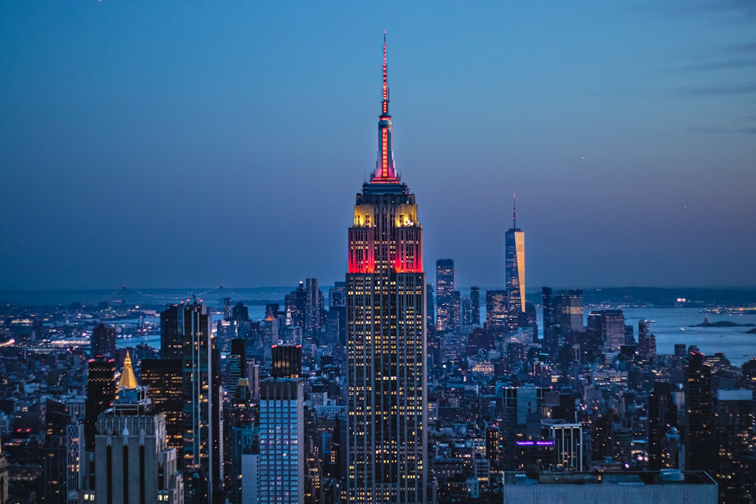 the empire building lit up in red and yellow,