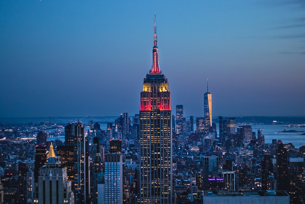 the empire building lit up in red and yellow