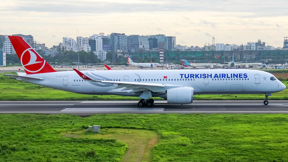 a large jetliner sitting on top of an airport runway