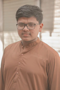Portrait of aun mohammad kidwai working on AI and data analytics solutions in a modern office setting.