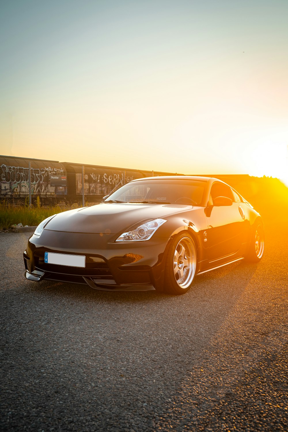 a black sports car parked in a parking lot