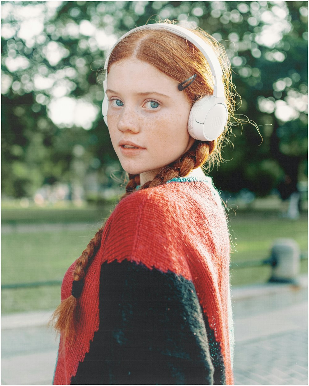 a woman with red hair wearing headphones