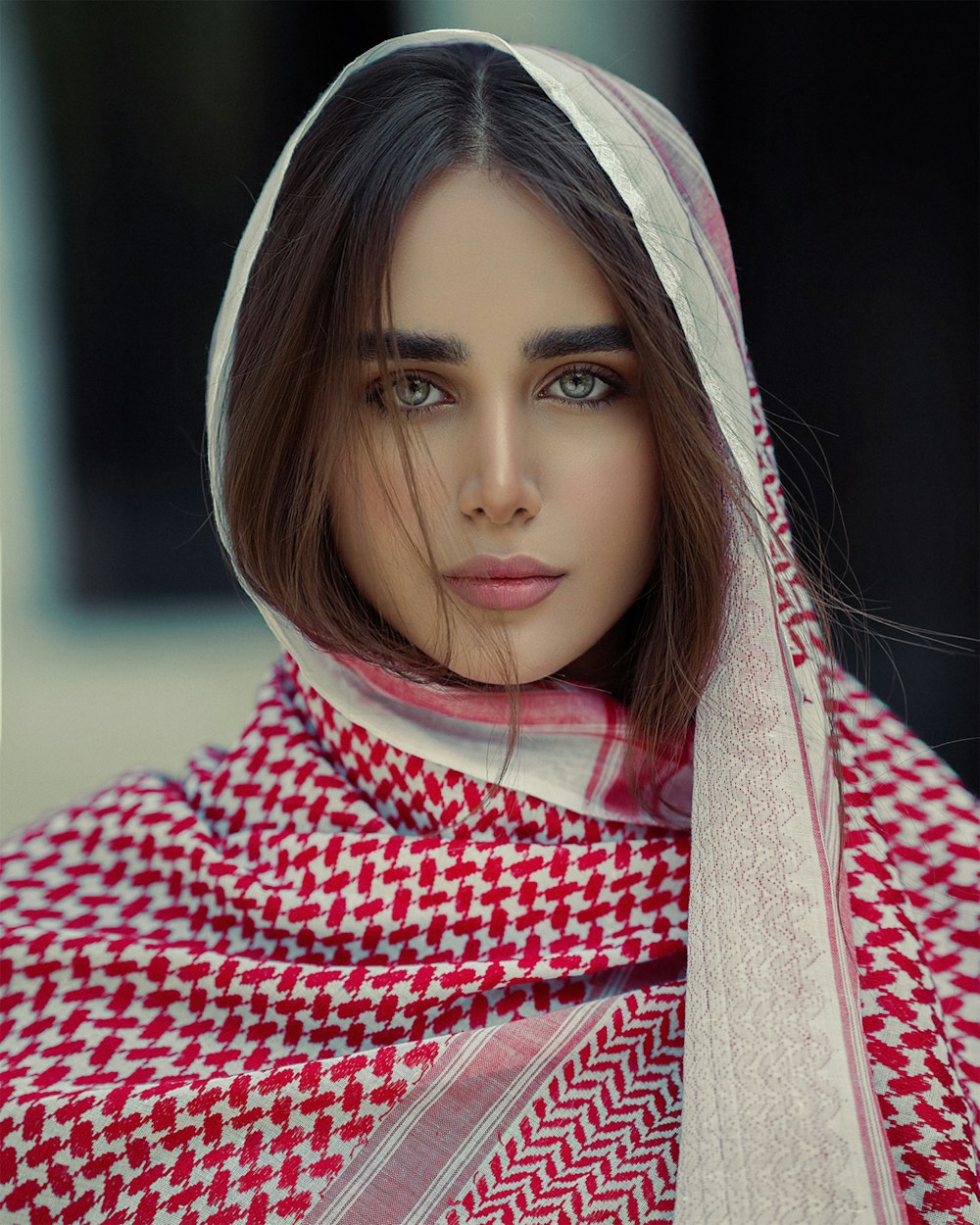 a woman wearing a red and white scarf