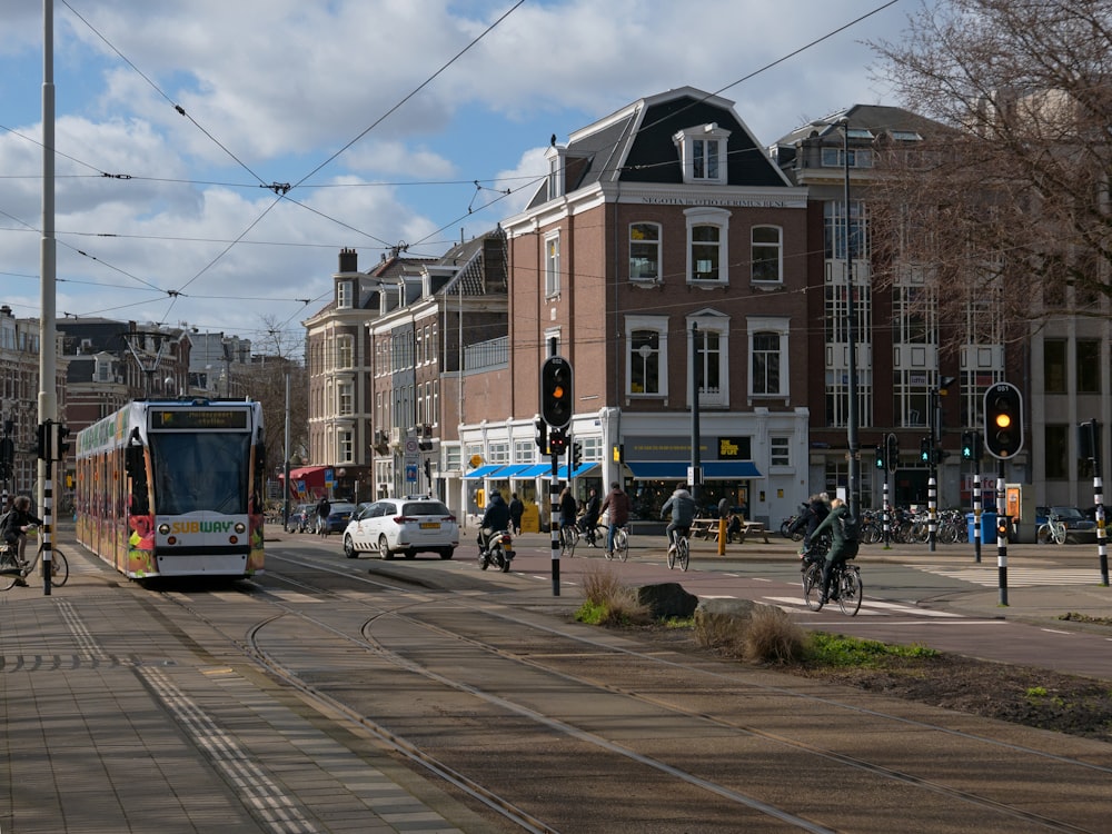 a city street filled with lots of traffic next to tall buildings