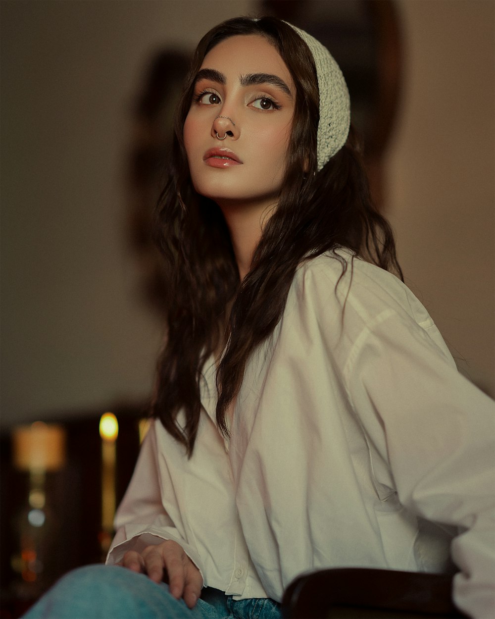 a woman with long hair wearing a white shirt