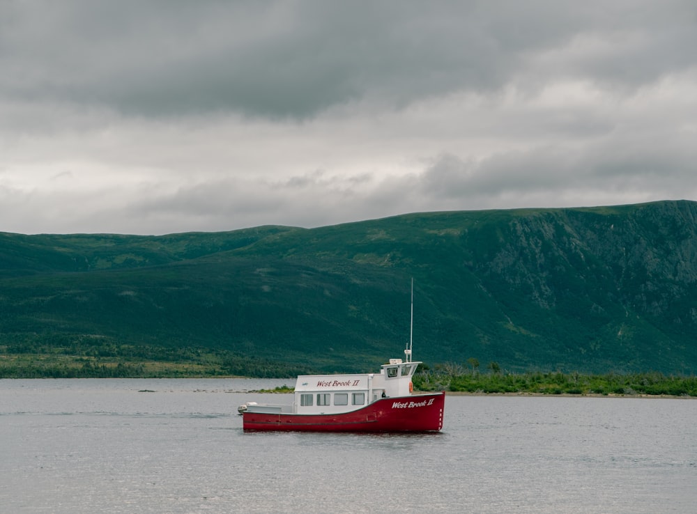 a red and white boat in a body of water