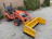 Image of a construction site with a bright orange tractor supplied by Tractoro in action.