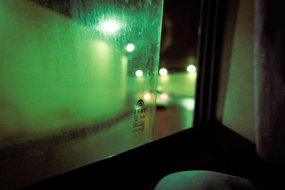 a view of a street at night through a window