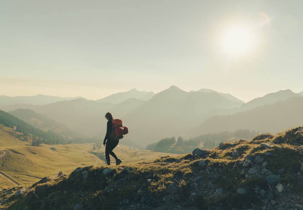 a person with a backpack walking up a hill