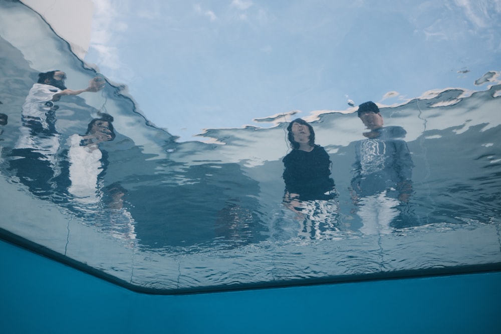 a group of people standing in the water