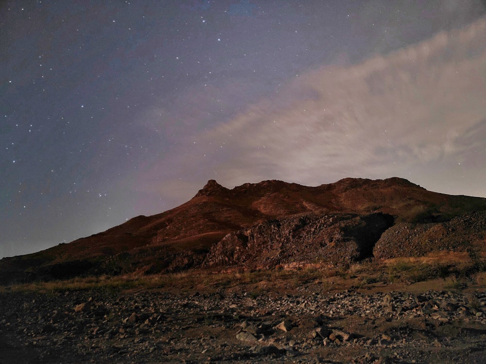 a mountain with a sky full of stars