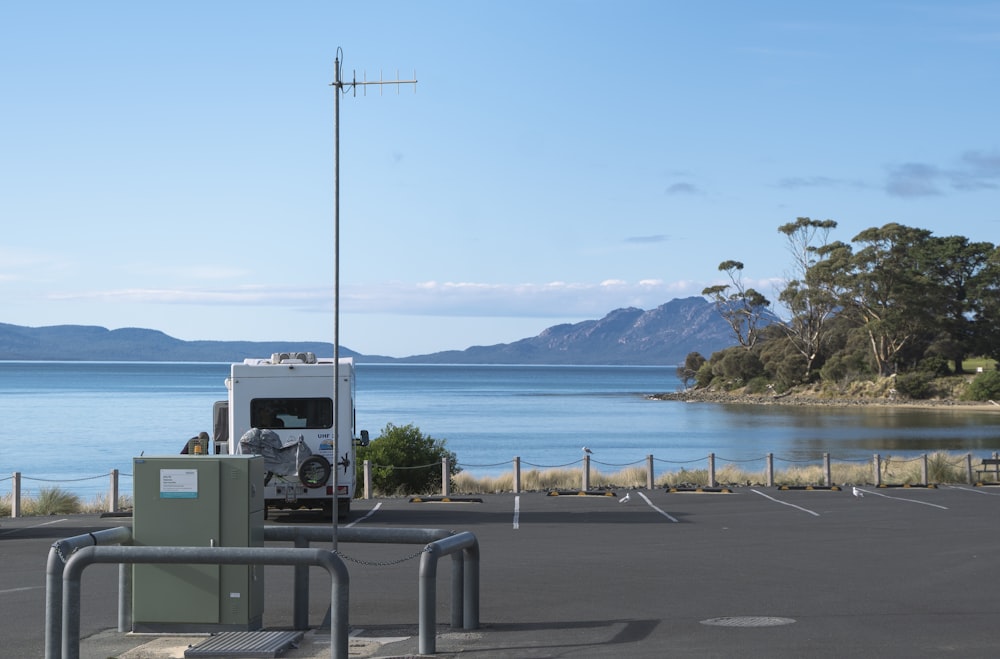 a parking lot next to a large body of water