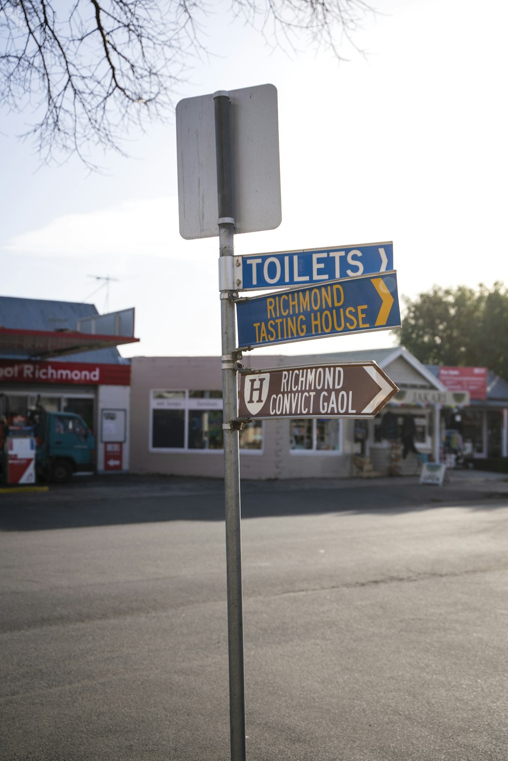 a street sign in front of a gas station