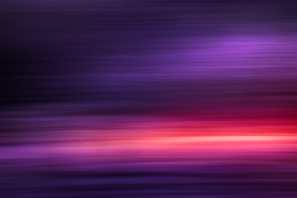 a blurry image of a purple and red background