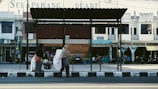 Women carrying large capacity foldable shopping bags at a local market.