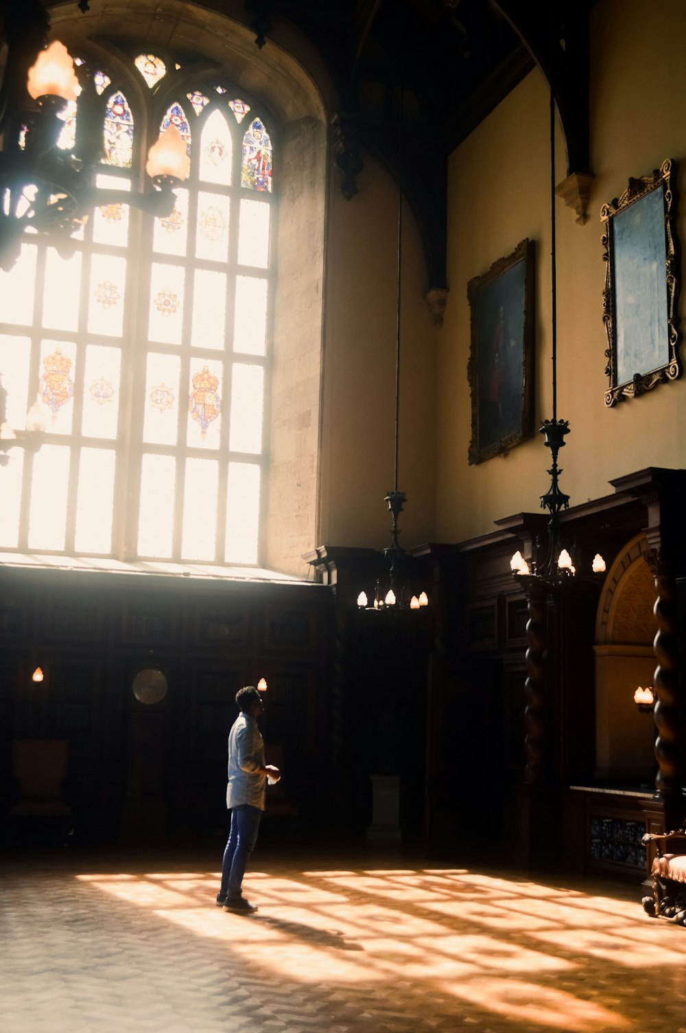 a person standing in a large room next to a window