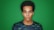Autistic advocate staring at camera with green screen behind him