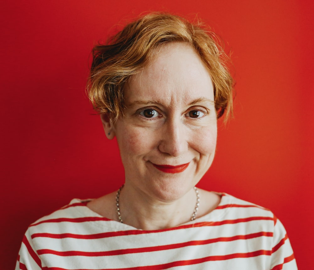 a woman in a striped shirt with a smile on her face