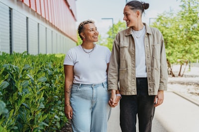 A happy in-loved couple holding hand walking down on the street