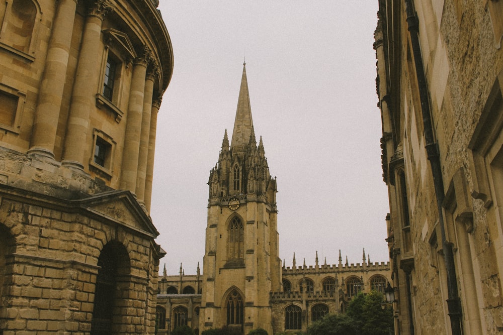 a large cathedral towering over a city next to tall buildings