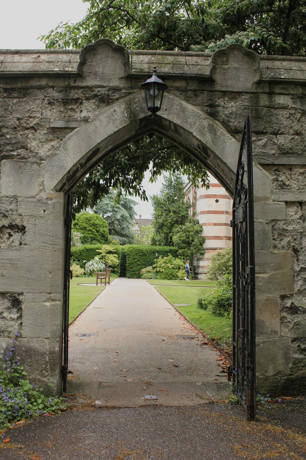 a stone arch with a light on top of it