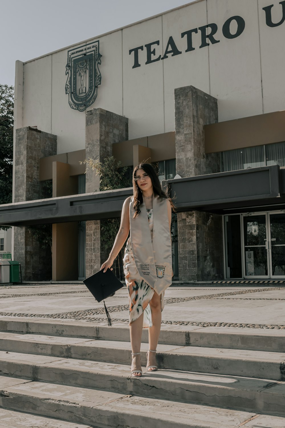 a woman walking down some steps in front of a building