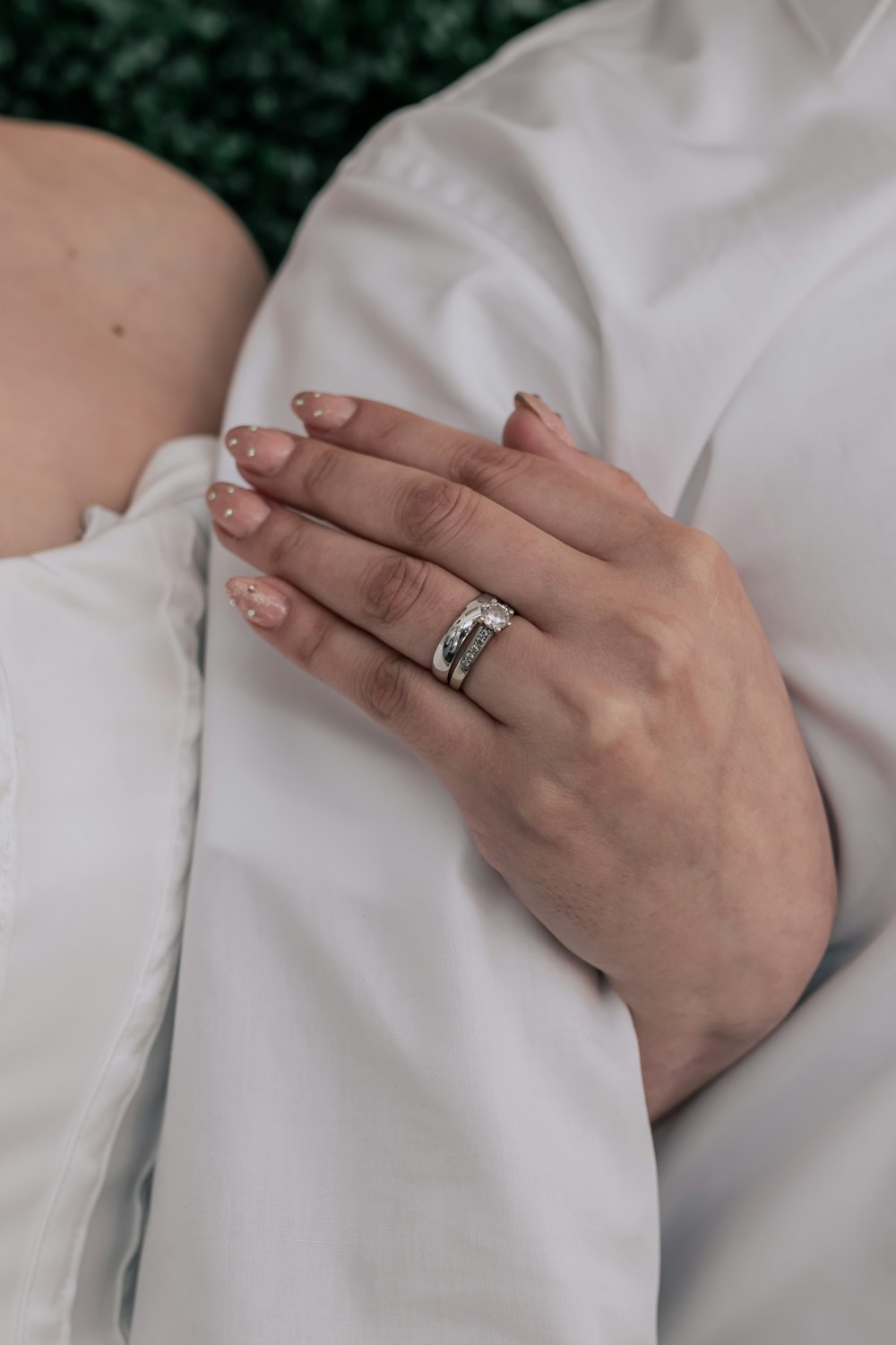 a close up of a person wearing a wedding ring