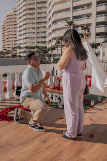 An intimate proposal moment on a rooftop terrace, featuring a sparkling engagement ring against the backdrop of iconic UAE landmarks.