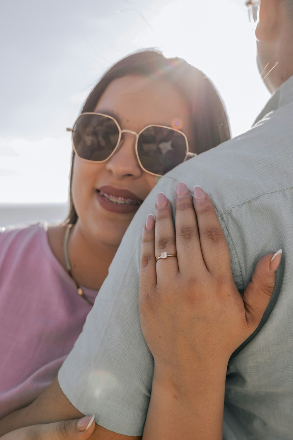 a man holding a woman on the beach